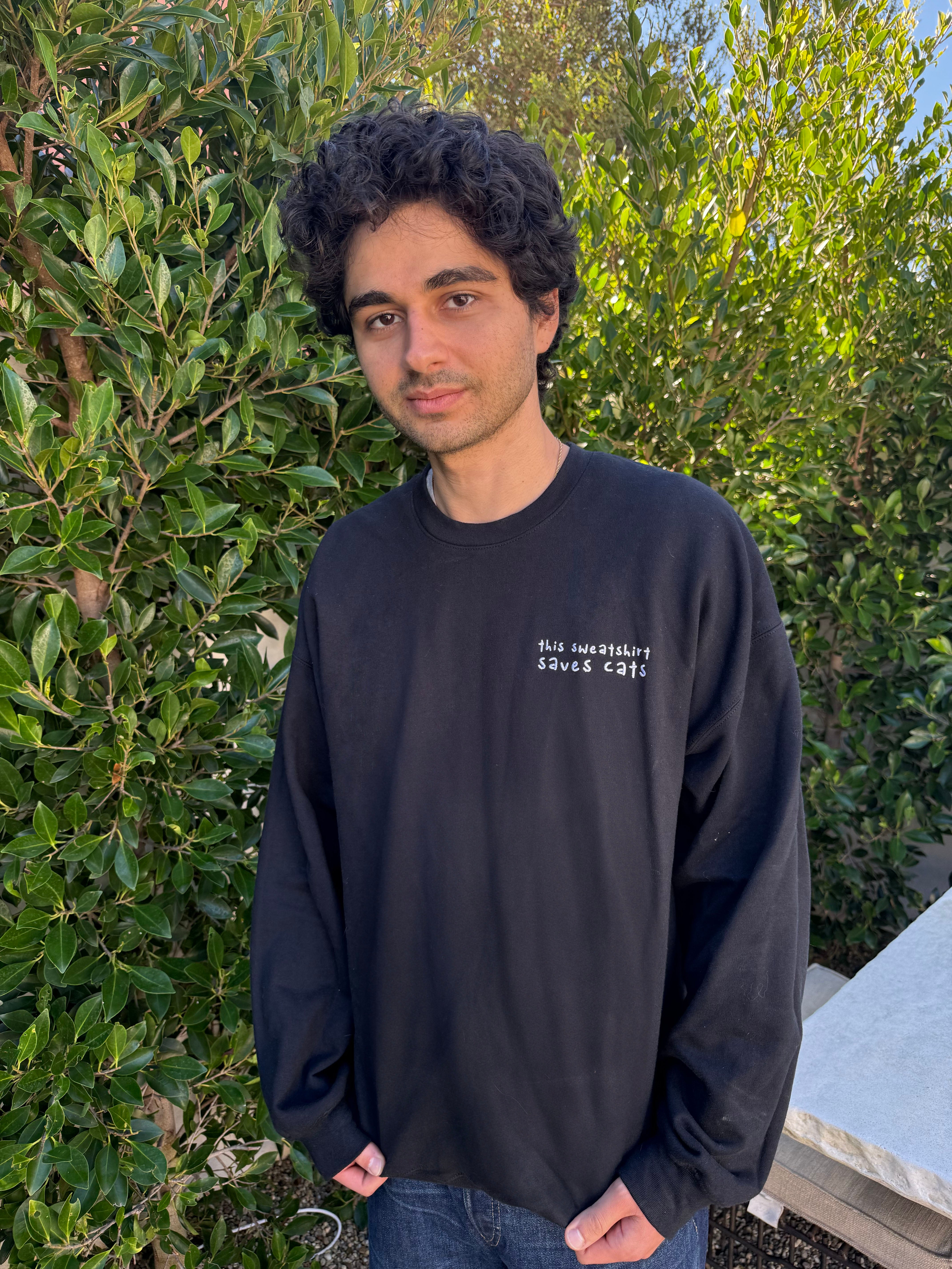 man wearing black embroidered crewneck