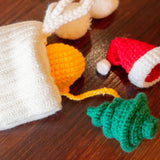 crocheted cat toys pictured next to white stocking