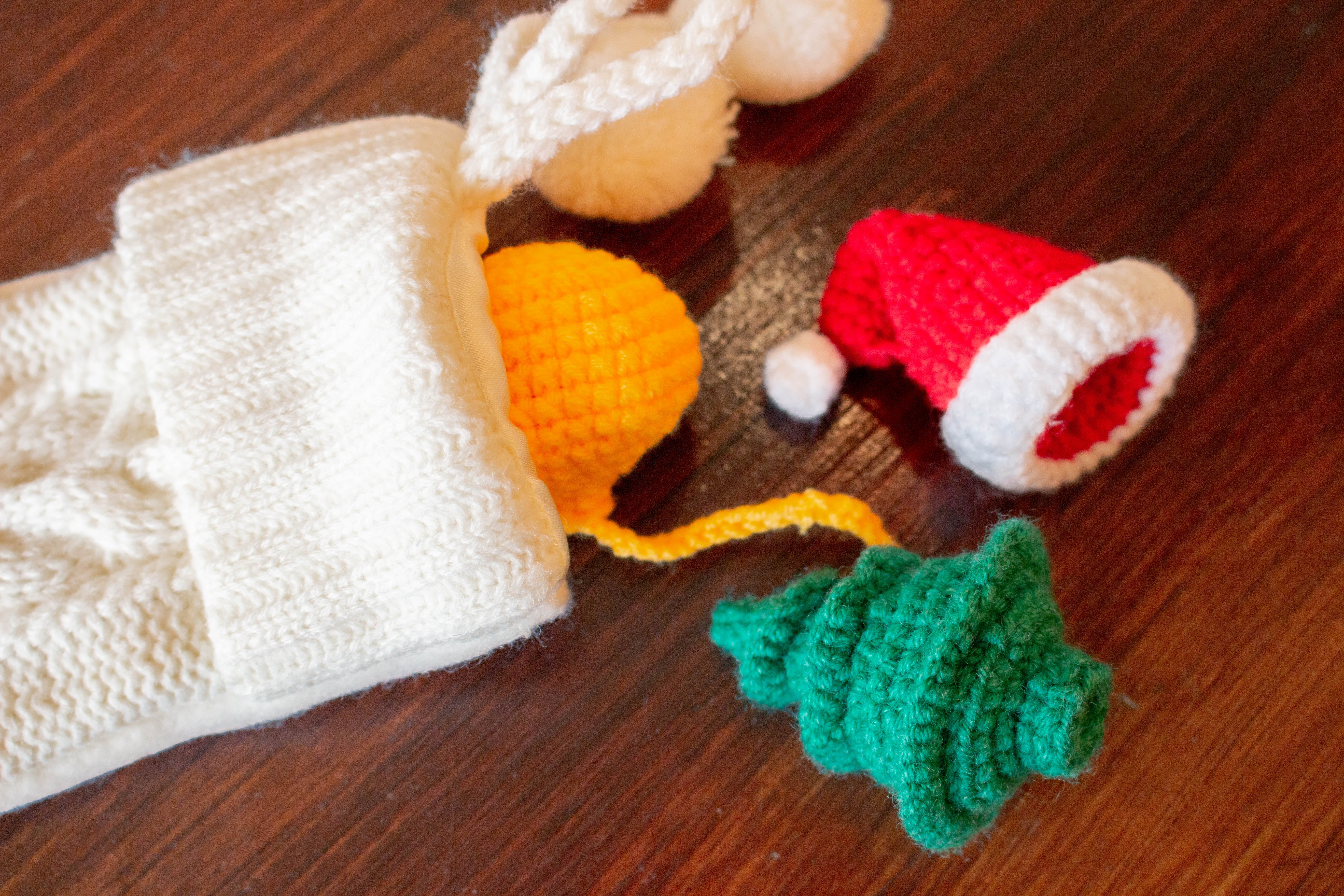 crocheted cat toys pictured next to white stocking