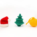 crocheted christmas cat toys on white background